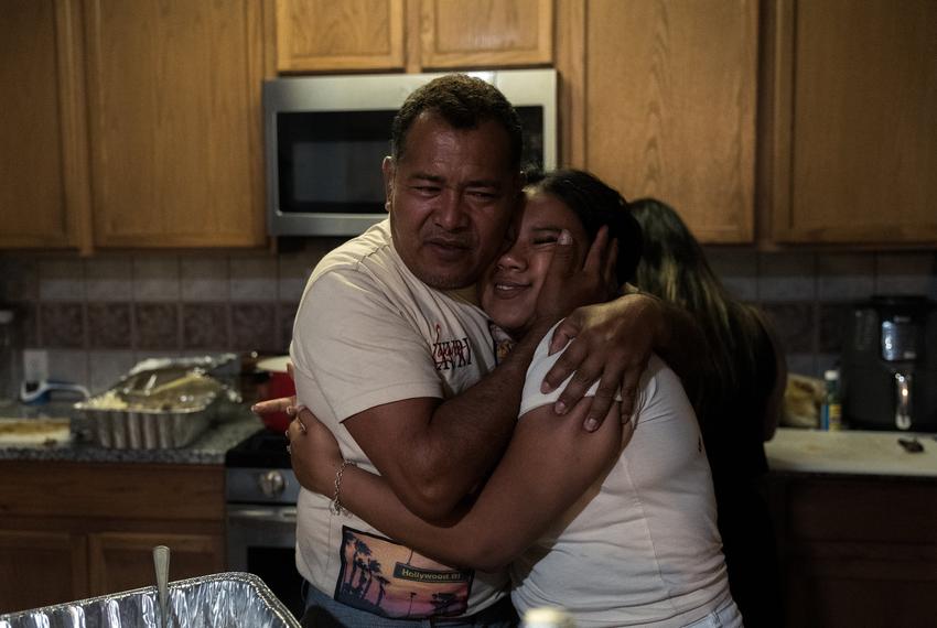 José Avila hugs his eldest daughter, Lisbet Avila, at her birthday celebration, Saturday, May 24, 2025, in Houston.(Lexi Parra for The Texas Tribune)